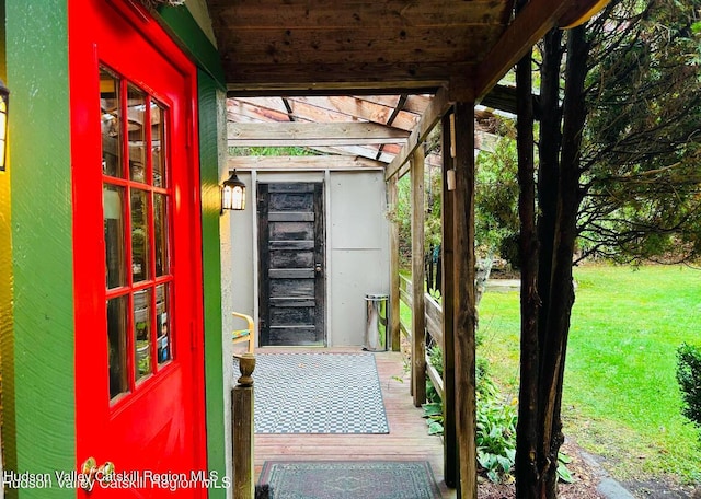 doorway to property featuring a lawn