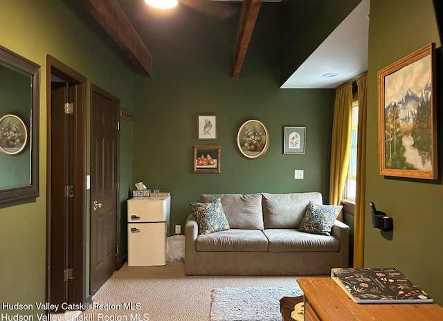 carpeted living room featuring beam ceiling