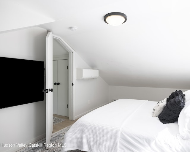 20 Sutton Hollow Rd, Windham, NY 12496 - bedroom featuring lofted ceiling, light wood-style floors, a wall unit AC, and baseboards