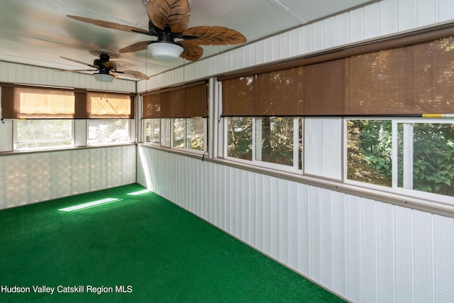 unfurnished sunroom with a wealth of natural light and ceiling fan