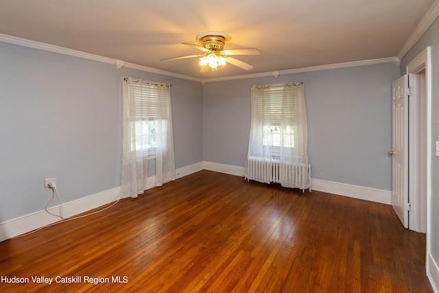 unfurnished room featuring radiator, dark wood-type flooring, a healthy amount of sunlight, and ornamental molding