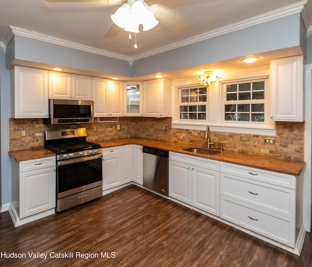 kitchen featuring white cabinetry, sink, tasteful backsplash, dark hardwood / wood-style flooring, and appliances with stainless steel finishes