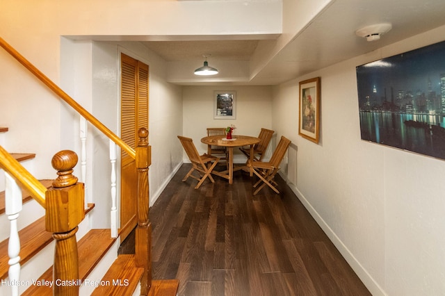 dining space featuring dark wood-type flooring