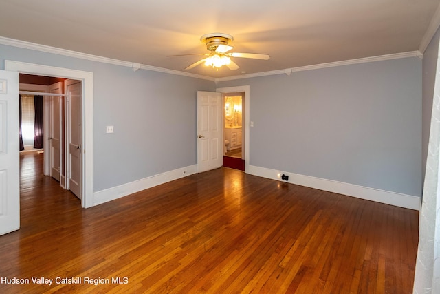 empty room featuring ornamental molding, ceiling fan, and dark wood-type flooring