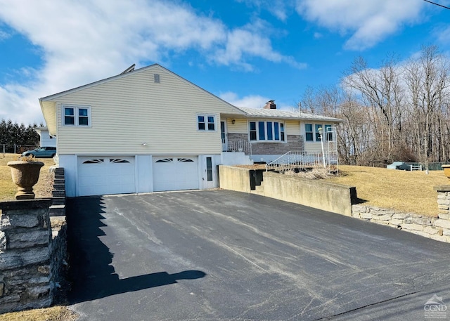 277 Anthony Ave, Hudson, NY 12534 - view of front facade with asphalt driveway, a garage, and a chimney