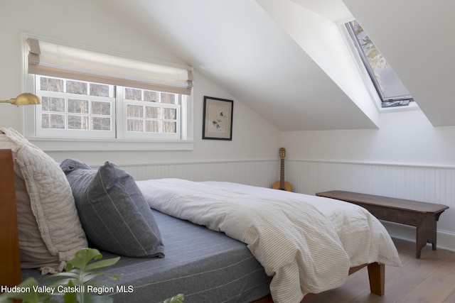 196 Wellington Ln, Cooperstown, NY 13326 - bedroom with wood finished floors, lofted ceiling, and wainscoting