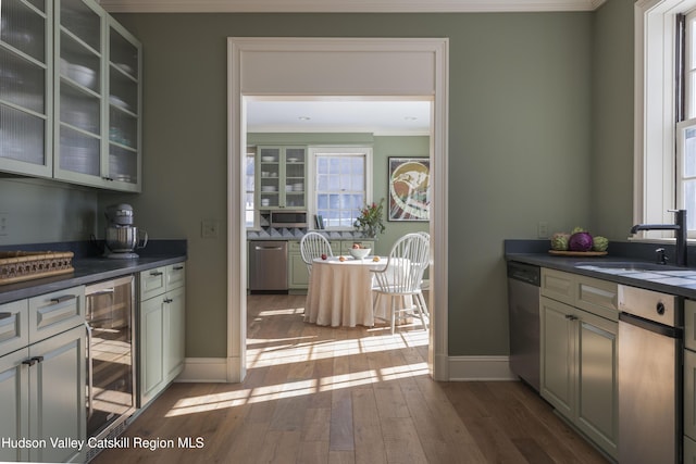 196 Wellington Ln, Cooperstown, NY 13326 - kitchen with ornamental molding, wine cooler, dark countertops, dishwasher, and hardwood / wood-style floors
