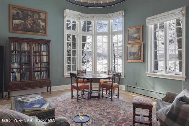 196 Wellington Ln, Cooperstown, NY 13326 - dining space with a baseboard heating unit and wood finished floors