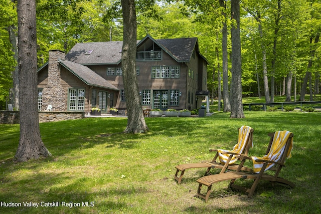 196 Wellington Ln, Cooperstown, NY 13326 - back of property with a yard, a chimney, and roof with shingles