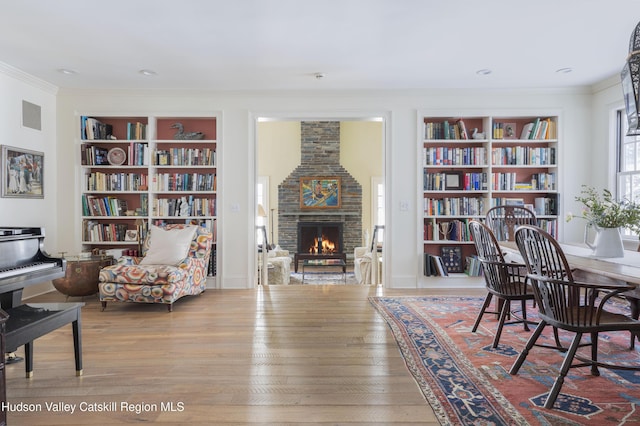 196 Wellington Ln, Cooperstown, NY 13326 - home office featuring built in features, ornamental molding, a brick fireplace, and wood finished floors