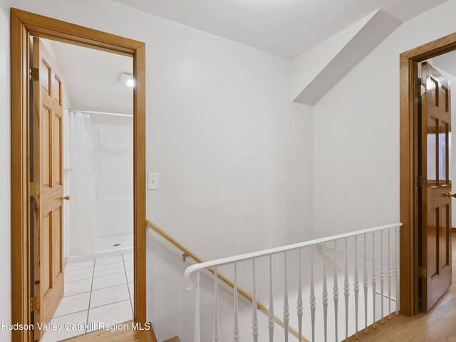 stairway with hardwood / wood-style flooring