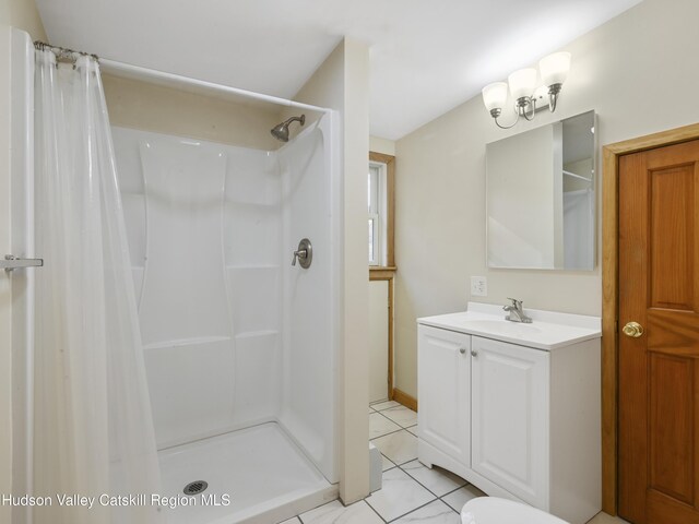 bathroom with tile patterned flooring, vanity, and a shower with shower curtain