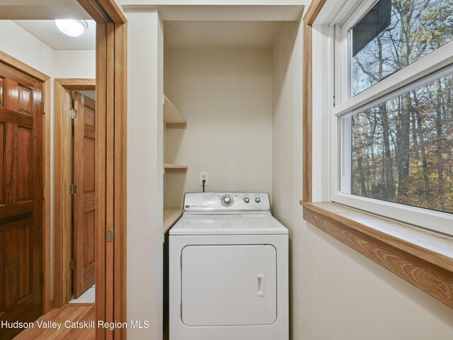 washroom with washer / clothes dryer, plenty of natural light, and hardwood / wood-style floors