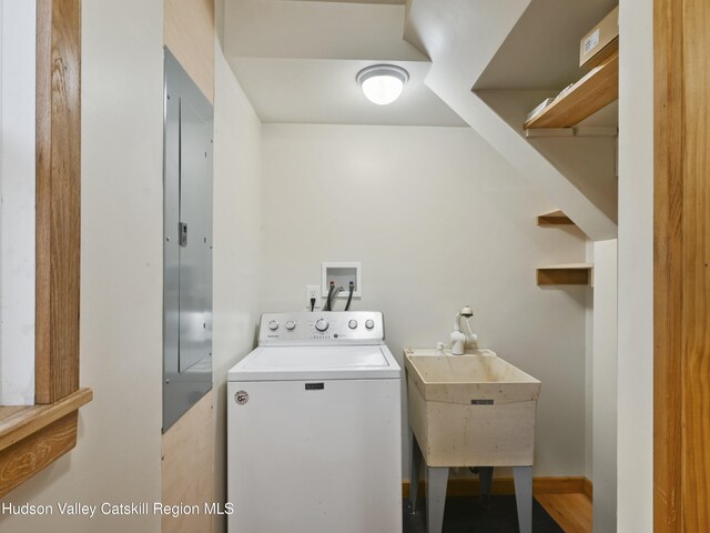 clothes washing area with washer / clothes dryer and sink