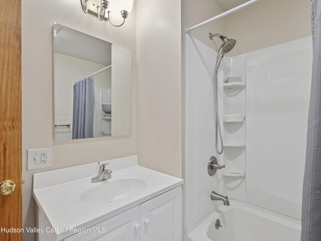 bathroom with shower / bathtub combination with curtain and vanity