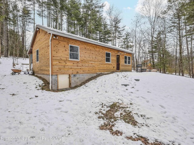 view of snow covered rear of property