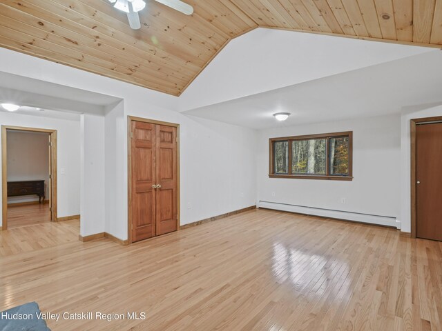 interior space with light wood-type flooring, a baseboard radiator, vaulted ceiling, and wood ceiling