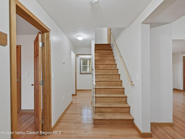 stairs with wood-type flooring