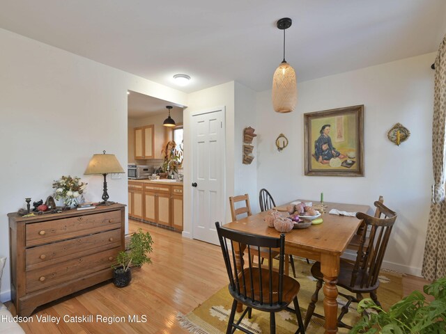 dining area featuring light wood-type flooring