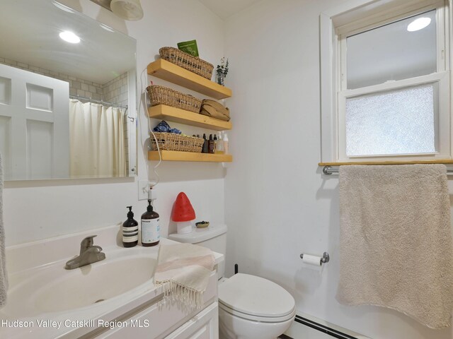 bathroom featuring a shower with curtain, vanity, toilet, and baseboard heating