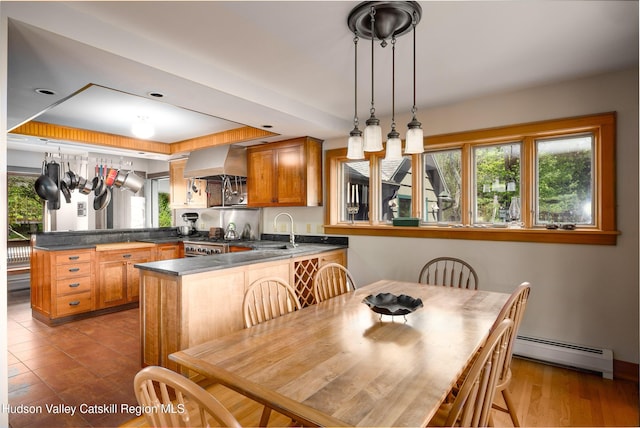 11 Louie Way, Woodstock, NY 12498 - kitchen featuring baseboard heating, a peninsula, dark countertops, and plenty of natural light