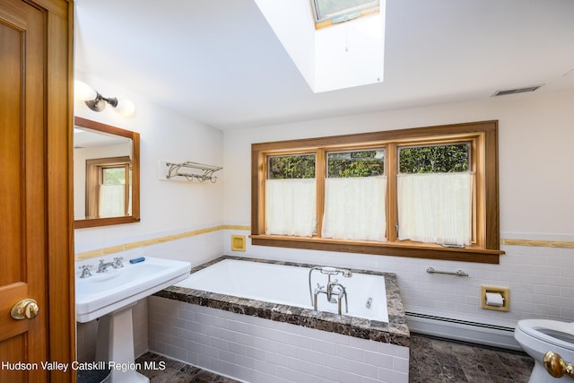 11 Louie Way, Woodstock, NY 12498 - bathroom featuring baseboard heating, a skylight, a bath, toilet, and wainscoting