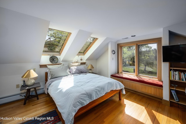 11 Louie Way, Woodstock, NY 12498 - bedroom featuring radiator heating unit, a skylight, wood-type flooring, lofted ceiling, and baseboard heating