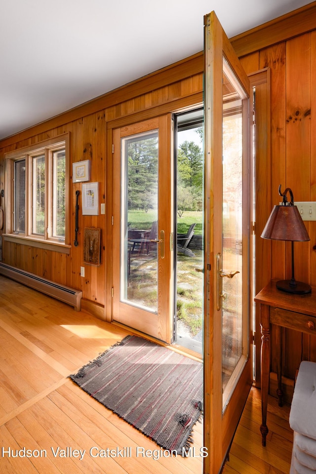 11 Louie Way, Woodstock, NY 12498 - doorway to outside with a baseboard radiator, plenty of natural light, wood finished floors, and wooden walls