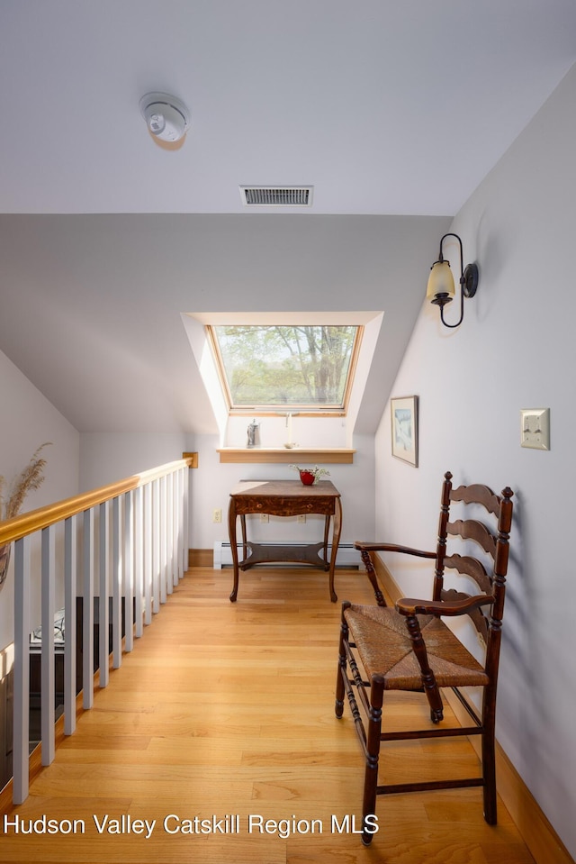 11 Louie Way, Woodstock, NY 12498 - hall with light wood-style flooring, a skylight, a baseboard radiator, baseboards, and a baseboard heating unit