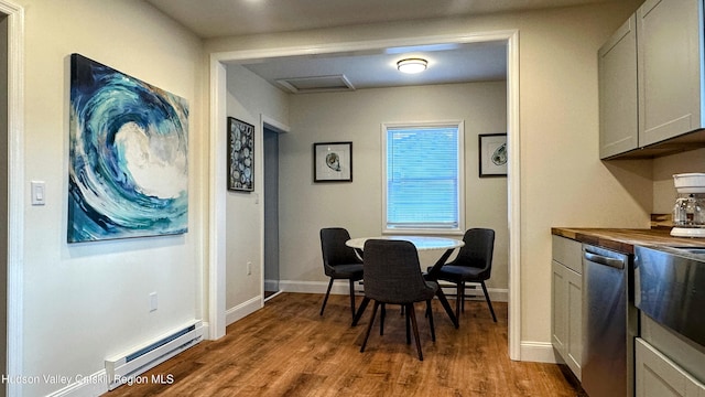 dining room with baseboard heating and wood-type flooring