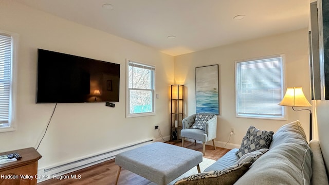 living room featuring a baseboard radiator and hardwood / wood-style floors