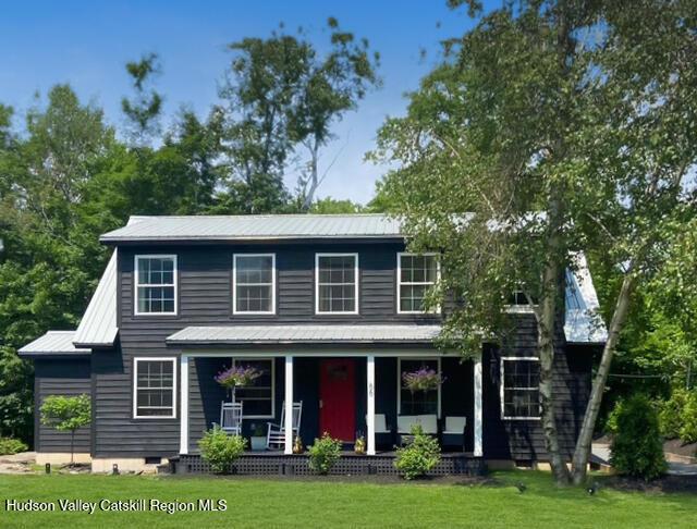 66 Maple Ave, Hunter, NY 12442 - view of front of home featuring covered porch, a front lawn, a metal roof, and crawl space