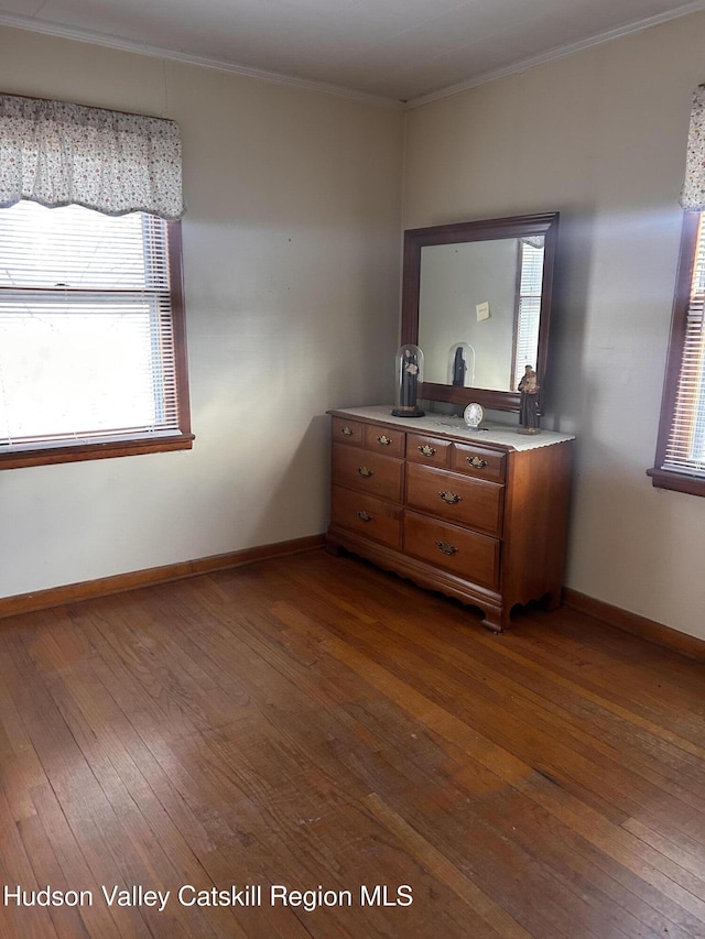 bedroom featuring dark hardwood / wood-style floors and crown molding