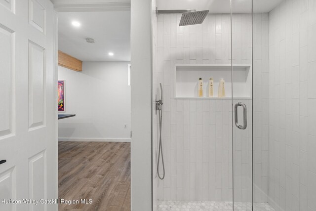 bathroom featuring walk in shower and wood-type flooring