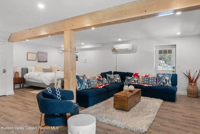 living room featuring beamed ceiling, wood-type flooring, and a wall mounted AC