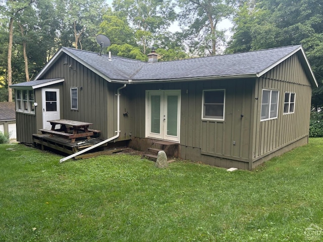 394 Peaceful Valley Rd, Canaan, NY 12029 - rear view of house with entry steps, roof with shingles, board and batten siding, and a lawn