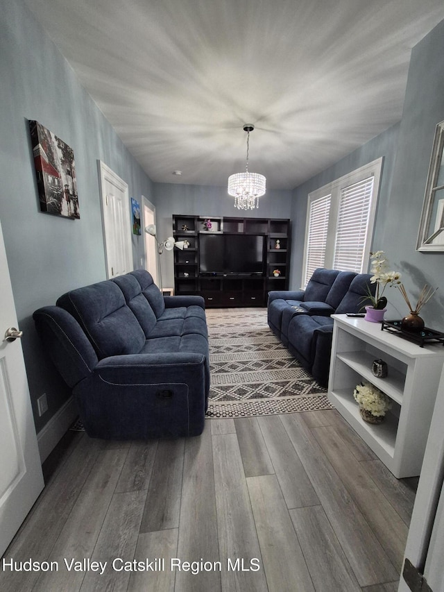 living area with wood finished floors and a chandelier