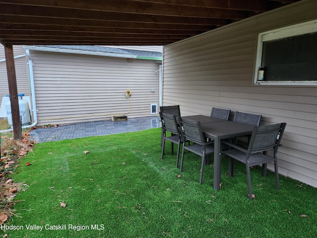 view of yard featuring a patio area and outdoor dining area