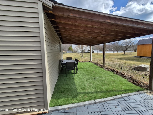 view of yard with a storage shed and an outbuilding