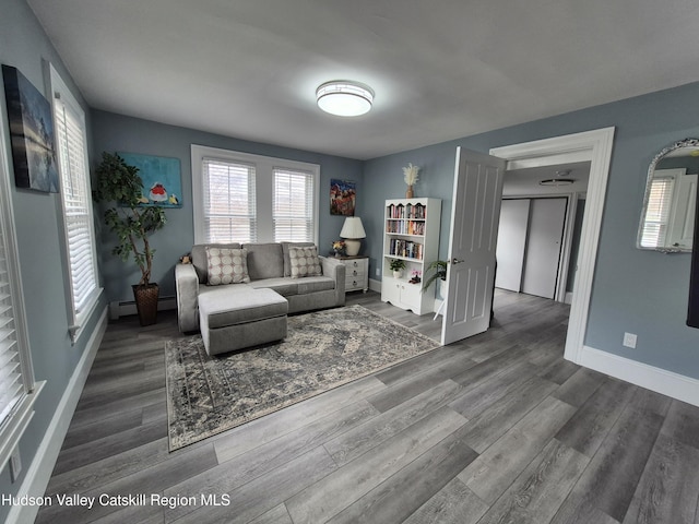 living area with wood finished floors and baseboards