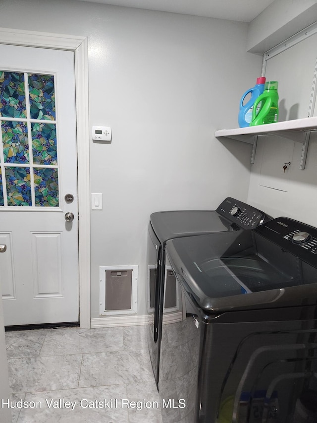 laundry room featuring laundry area and washing machine and clothes dryer