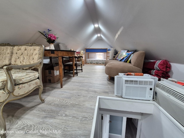 interior space featuring lofted ceiling and wood finished floors