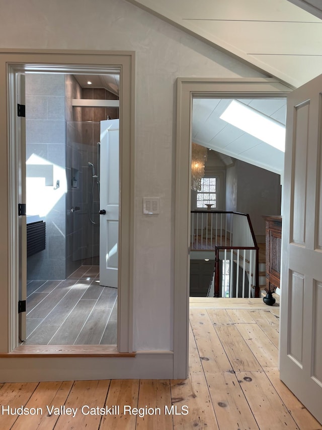 416 Hapeman Hill Rd, Red Hook, NY 12571 - hall with lofted ceiling, wood-type flooring, and an upstairs landing