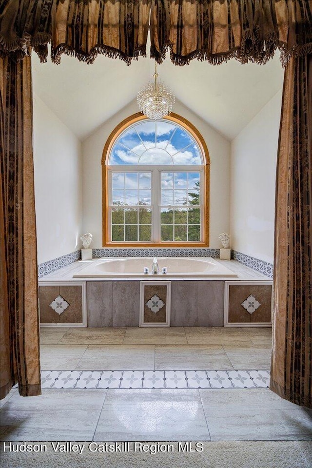 424 Joys Ln, Hurley, NY 12443 - full bath featuring tile patterned flooring, healthy amount of natural light, vaulted ceiling, and a garden tub
