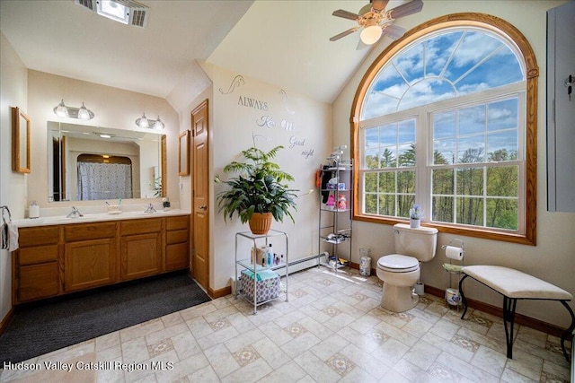 424 Joys Ln, Hurley, NY 12443 - bathroom with baseboards, a ceiling fan, toilet, double vanity, and lofted ceiling