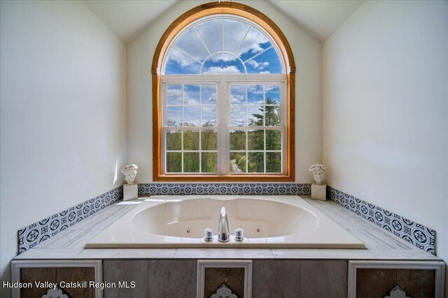 424 Joys Ln, Hurley, NY 12443 - bathroom with vaulted ceiling, healthy amount of natural light, and a jetted tub