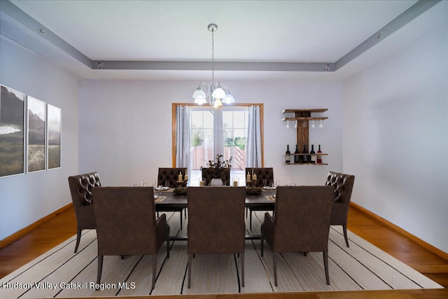 424 Joys Ln, Hurley, NY 12443 - dining area featuring a chandelier, wood finished floors, and a raised ceiling