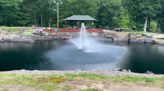 view of water feature featuring a view of trees and a gazebo