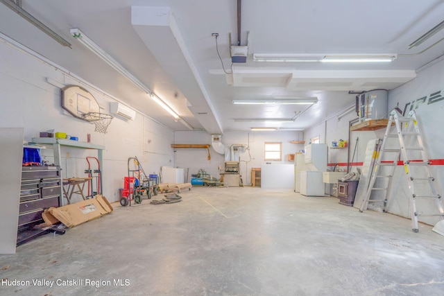 garage featuring a wall mounted AC, a sink, and a garage door opener