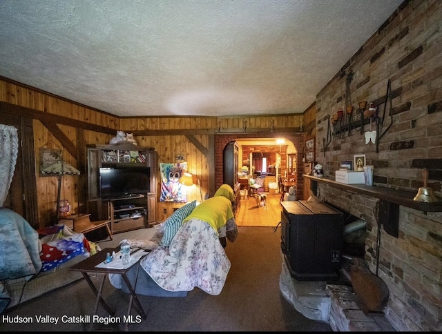 125 County Route 26a, Stuyvesant, NY 12106 - living area featuring wood walls, a textured ceiling, and arched walkways
